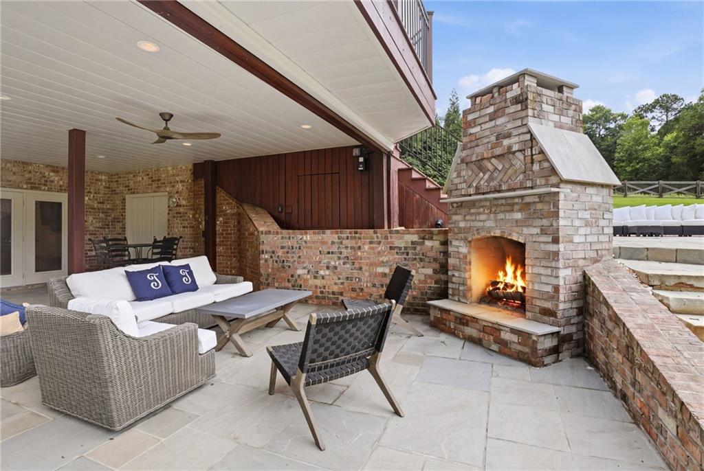 2950 Callie Still Road Lawrenceville, GA 30045 - Photo 45 of 77 a outdoor space with the couches and a fireplace