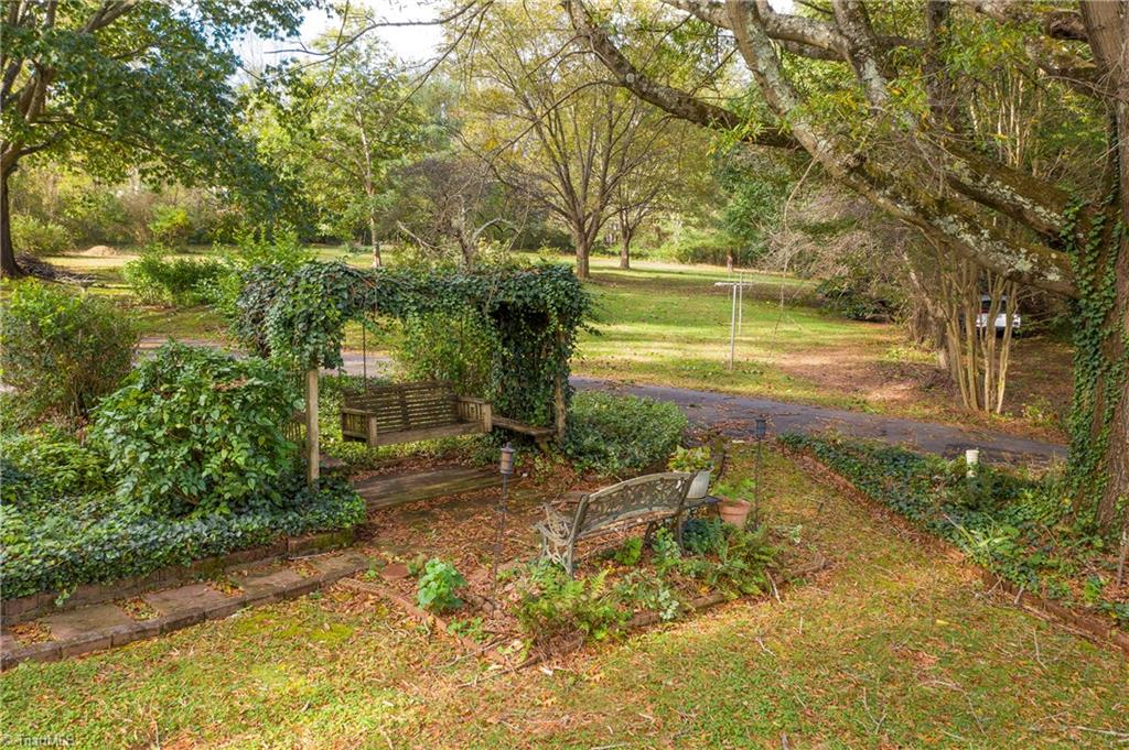 9092 Lasater Road Clemmons, NC 27012 - Photo 7 of 39 Peaceful garden space with swing and park bench