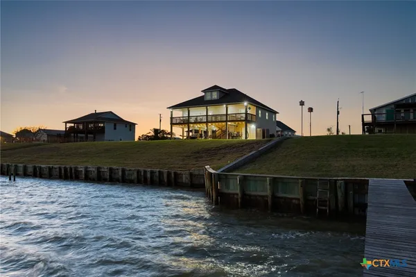 a view of a swimming pool with an outdoor seating and a garden