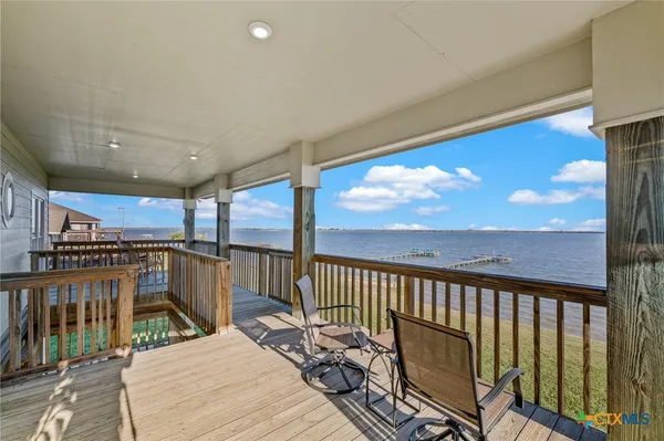 a bedroom with two beds and a chandelier