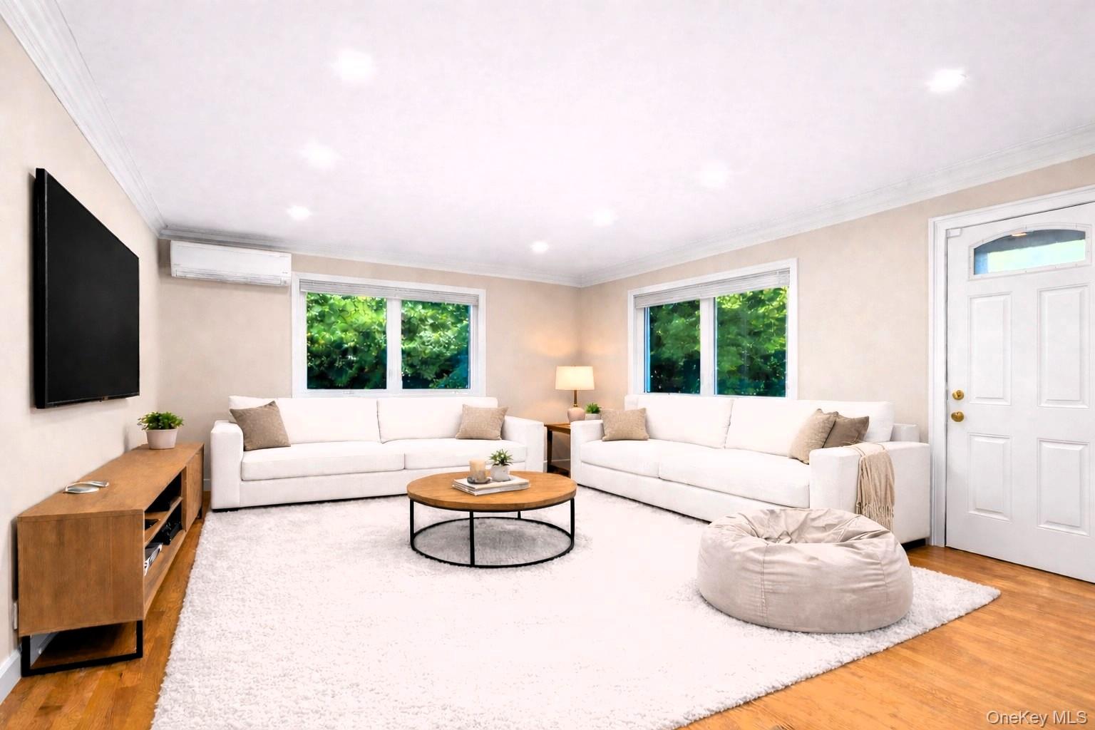 88 Spier Road Scarsdale, NY 10583 - Photo 11 of 26 Family Room with an split unit, wood finished floors, healthy amount of natural light, digitally staged