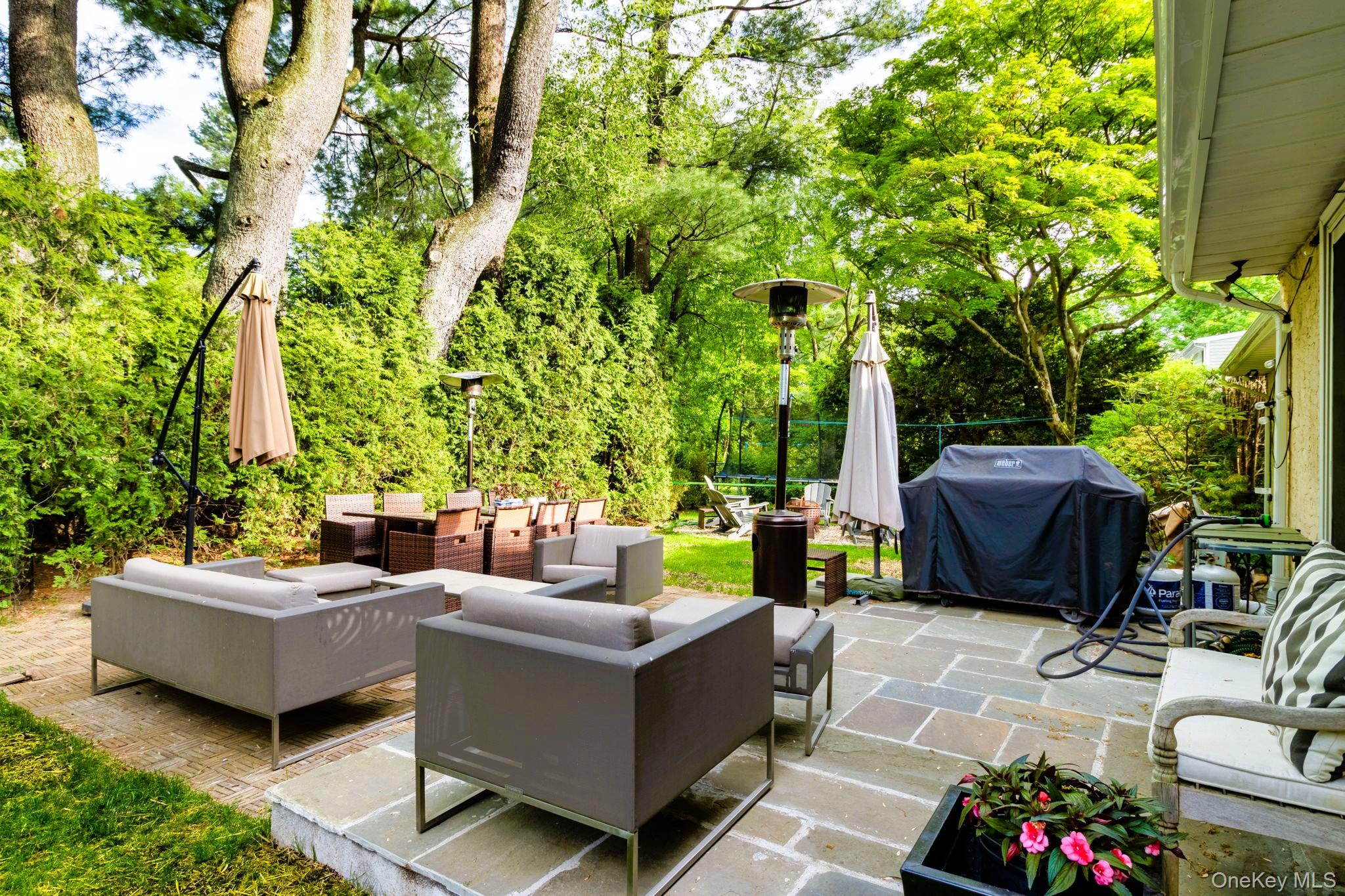 88 Spier Road Scarsdale, NY 10583 - Photo 22 of 26 View of patio featuring grilling area, an outdoor hangout area, and view of scattered trees