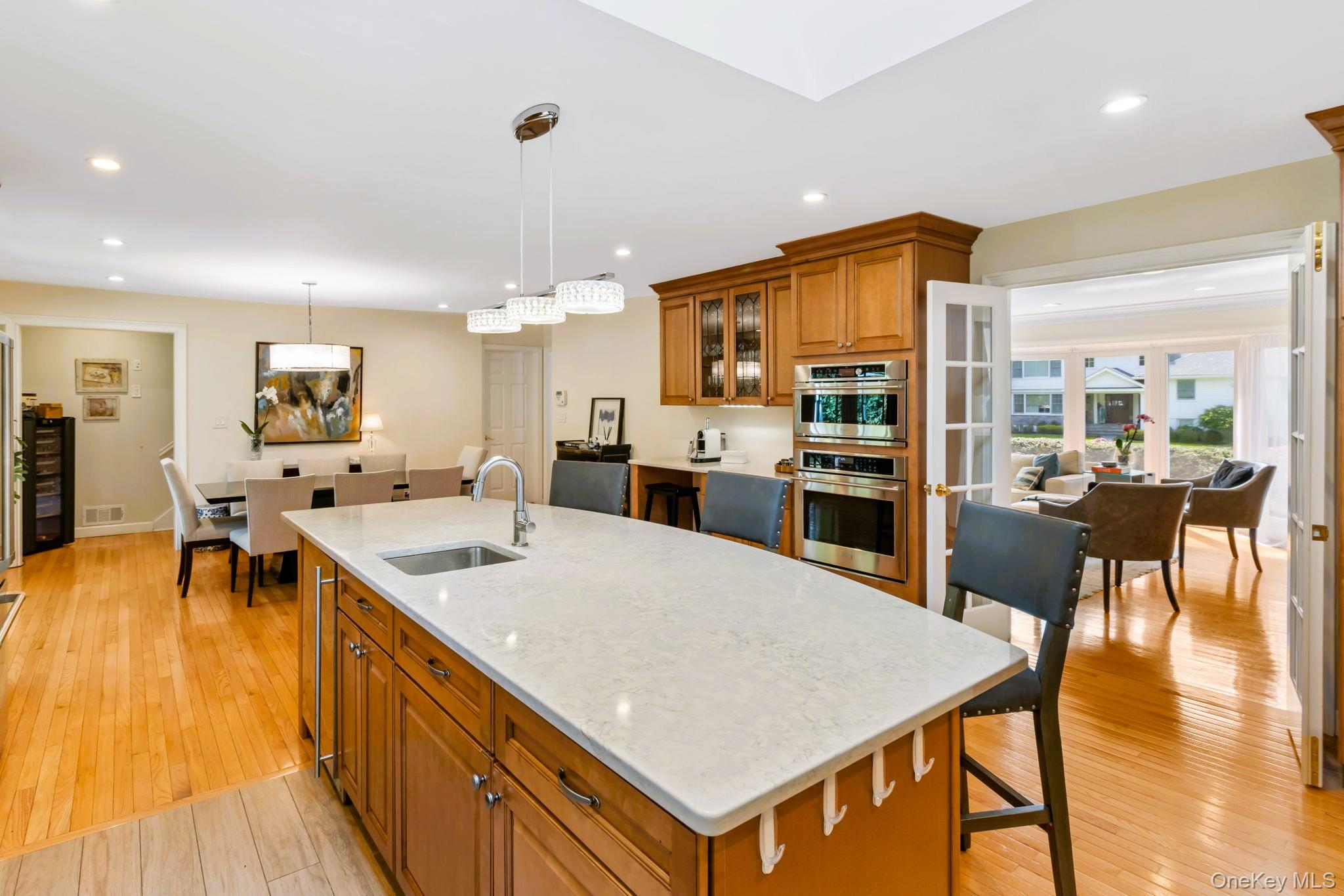 88 Spier Road Scarsdale, NY 10583 - Photo 8 of 26 Kitchen with stainless steel appliances, a skylight, and oversized island