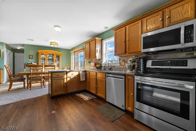 a view of a dining room with furniture and a chandelier