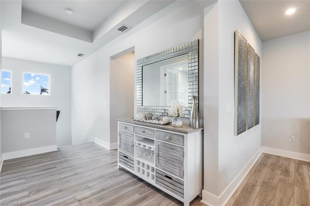 4705 Arboretum Circle, Unit 203 Naples, FL 34112 - Photo 12 of 31 a room with a dresser and a mirror