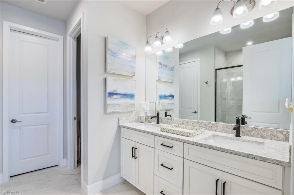 4705 Arboretum Circle, Unit 203 Naples, FL 34112 - Photo 15 of 31 a bathroom with a sink double vanity and a mirror