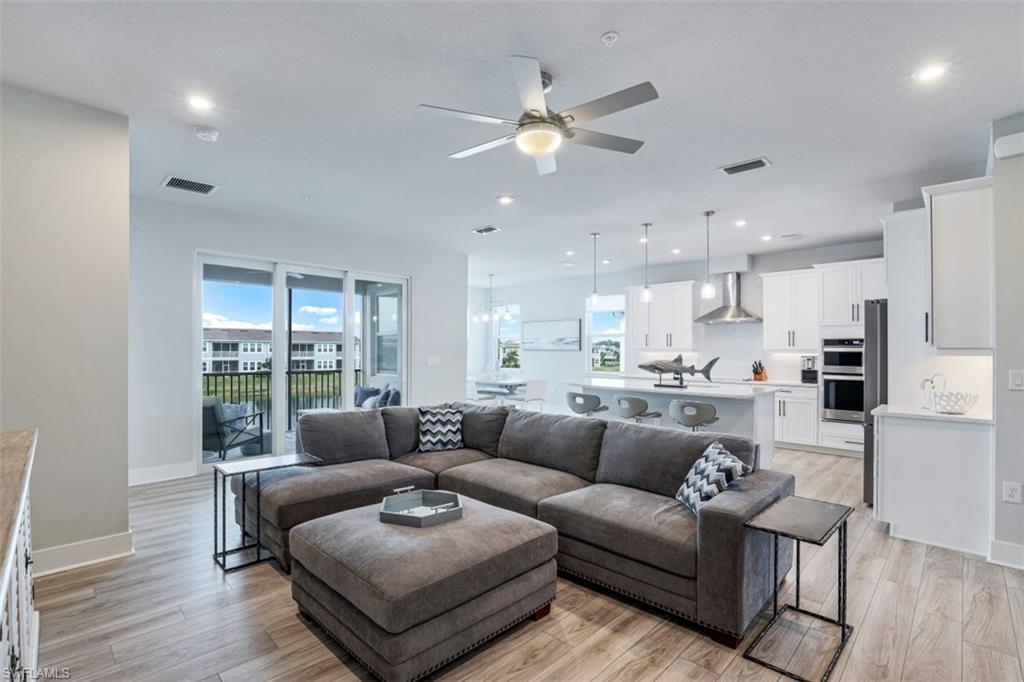4705 Arboretum Circle, Unit 203 Naples, FL 34112 - Photo 2 of 31 a living room with furniture and a large window