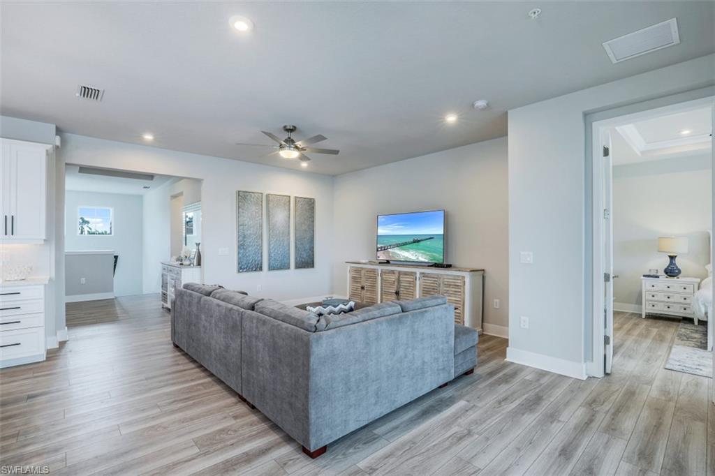 4705 Arboretum Circle, Unit 203 Naples, FL 34112 - Photo 5 of 31 a living room with furniture and a wooden floor