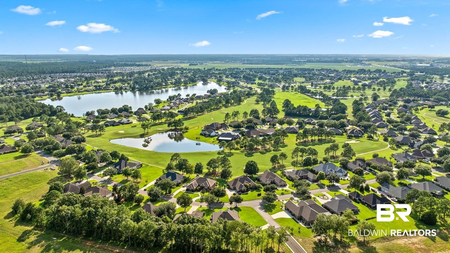 23357 Carnoustie Drive Foley, AL 36535 - Photo 93 of 99 Aerial perspective of suburban area featuring a large body of water and a local golf course