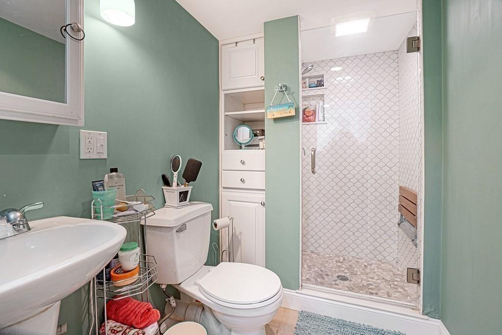 9 Madison Road Wellesley, MA 02481 - Photo 32 of 40 a white toilet sitting next to a bathroom sink