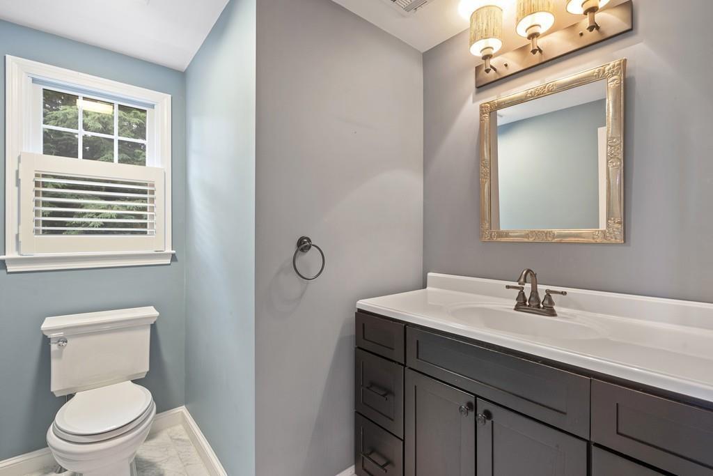 9 Madison Road Wellesley, MA 02481 - Photo 33 of 40 a bathroom with a toilet a sink and mirror