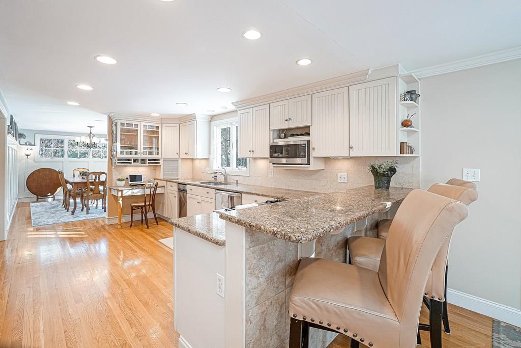 9 Madison Road Wellesley, MA 02481 - Photo 6 of 40 a kitchen with a table chairs microwave and cabinets