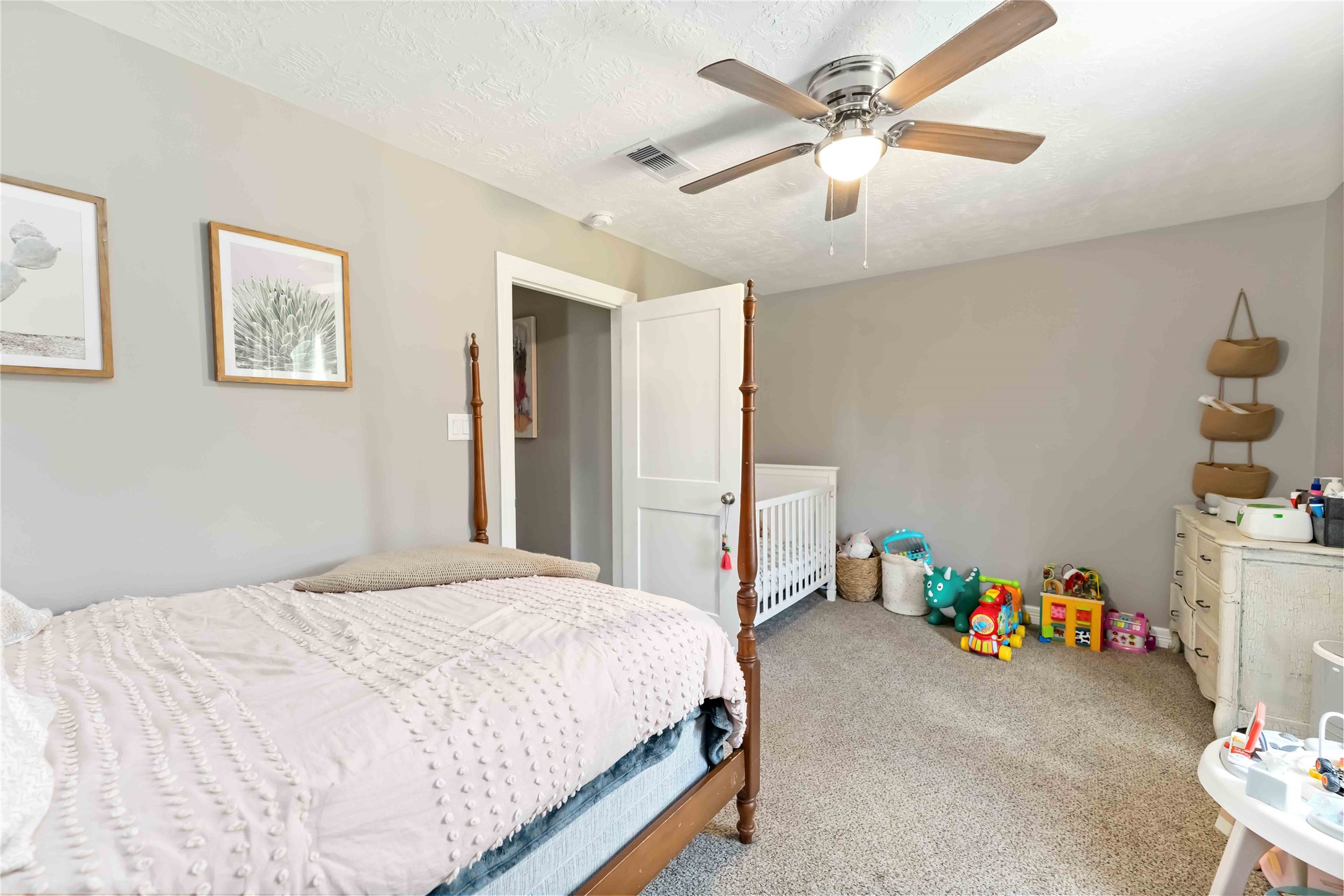 2615 Commerce Street Liverpool, TX 77577 - Photo 14 of 23 a bedroom with a bed and a chandelier