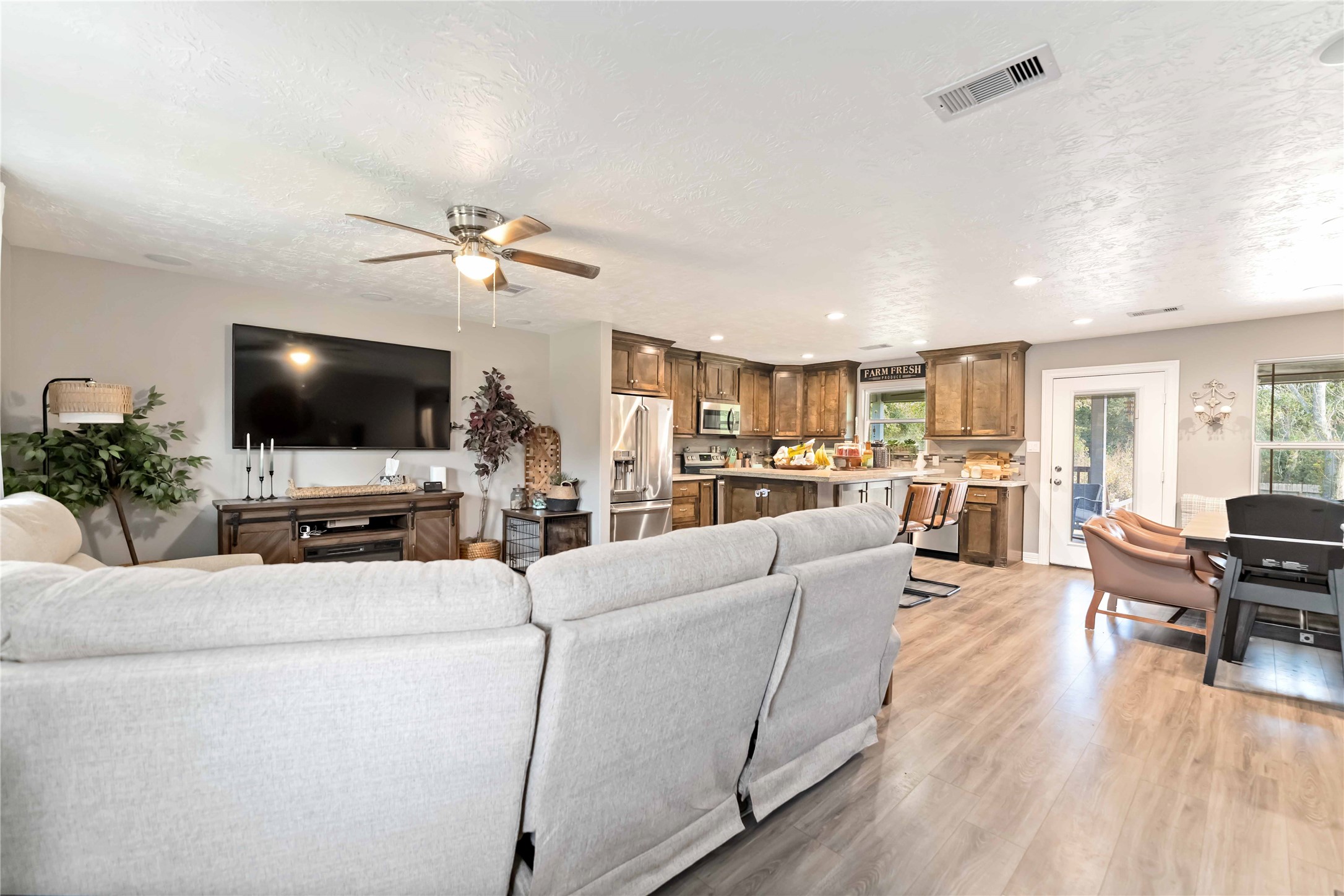 2615 Commerce Street Liverpool, TX 77577 - Photo 4 of 23 a living room with furniture and a flat screen tv