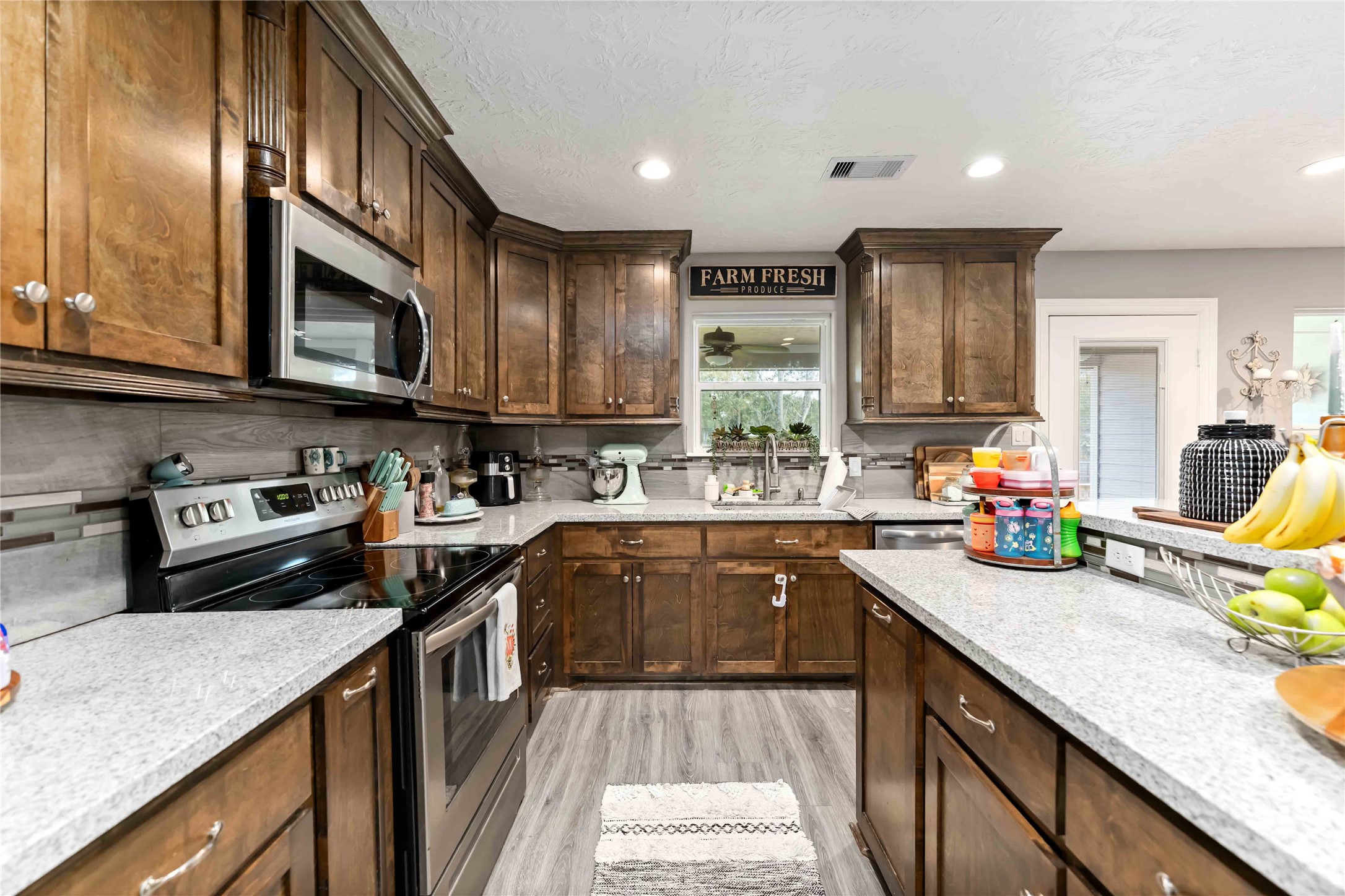 2615 Commerce Street Liverpool, TX 77577 - Photo 7 of 23 a kitchen with stainless steel appliances granite countertop a sink stove and cabinets