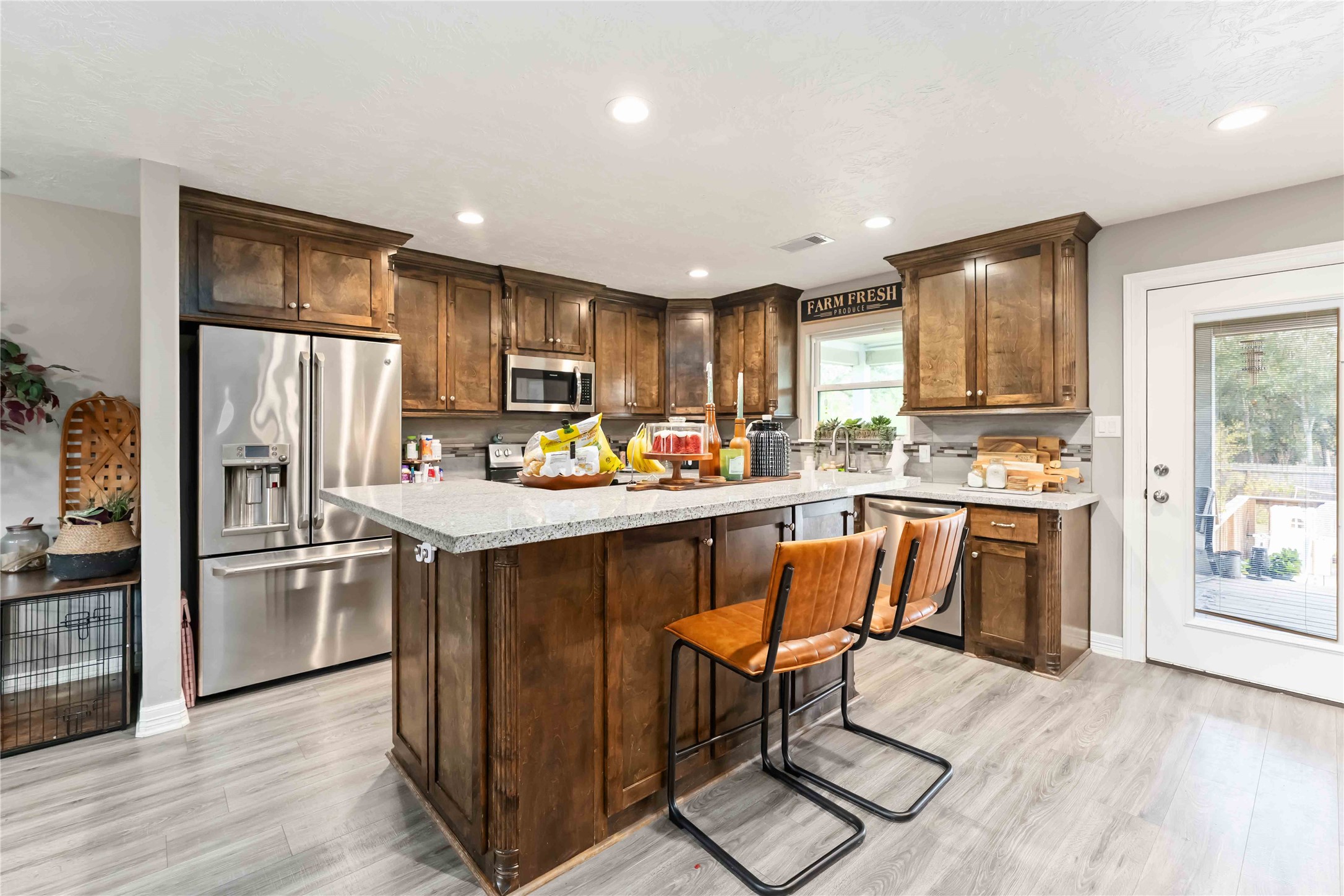 2615 Commerce Street Liverpool, TX 77577 - Photo 8 of 23 a kitchen with granite countertop wooden cabinets and stainless steel appliances