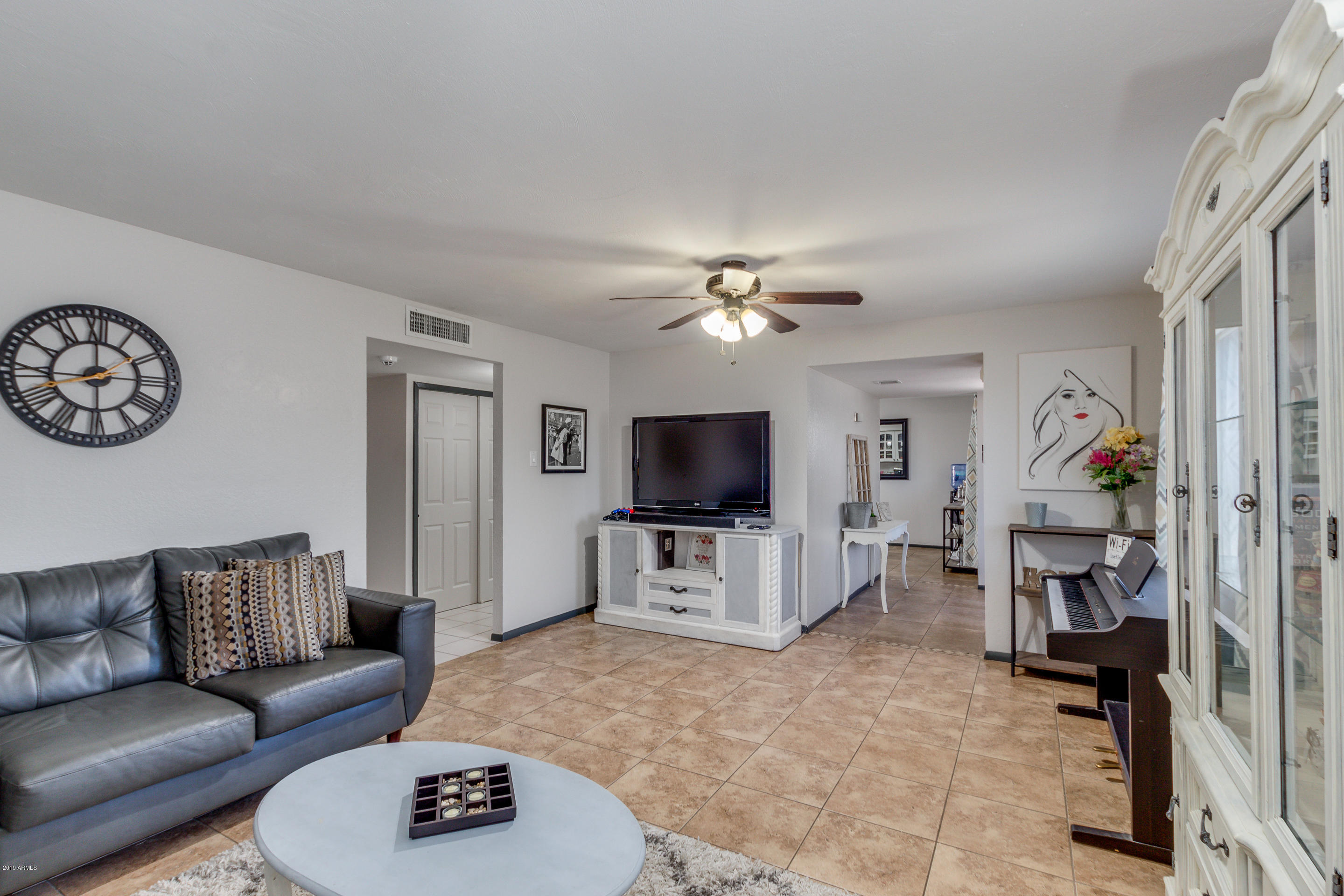 3622 West Hearn Road Phoenix, AZ 85053 - Photo 7 of 42 a living room with furniture and a flat screen tv