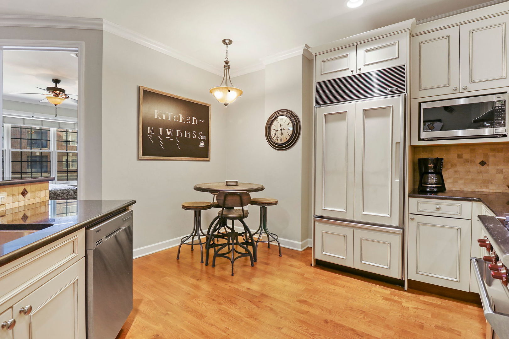 50 North Plum Grove Road, Unit 201E Palatine, IL 60067 - Photo 5 of 22 a kitchen with a refrigerator and a table