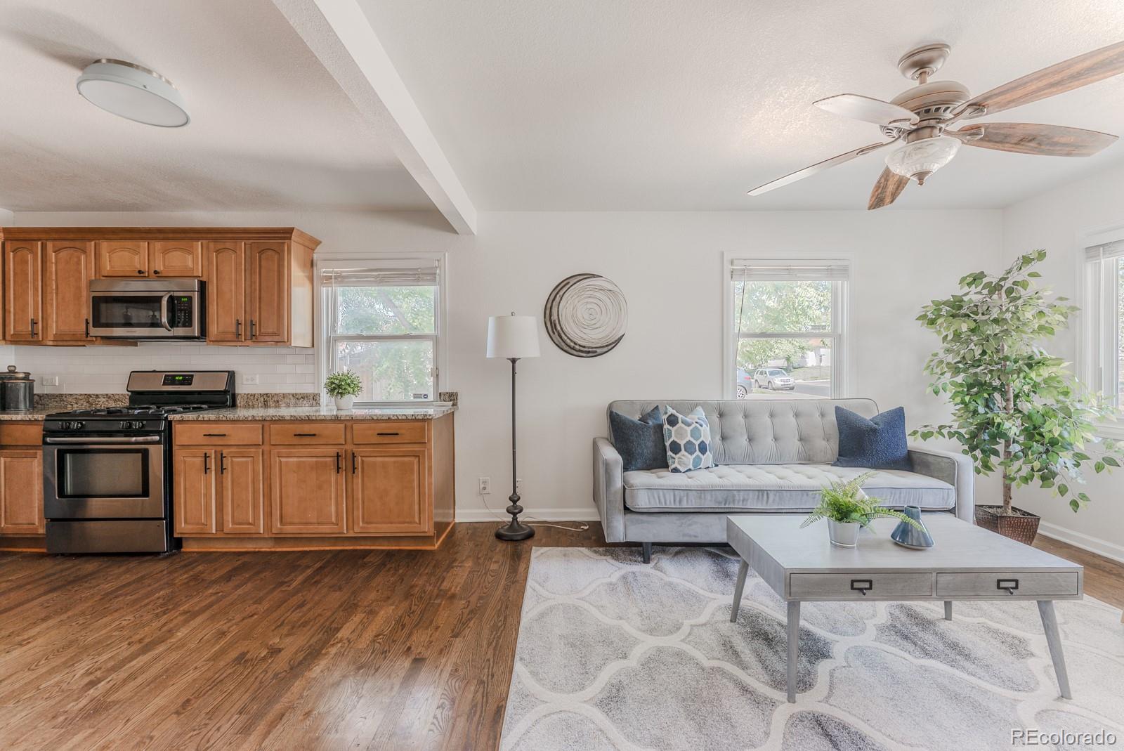 2260 Lilly Drive Thornton, CO 80229 - Photo 12 of 33 a living room with furniture and a wooden floor