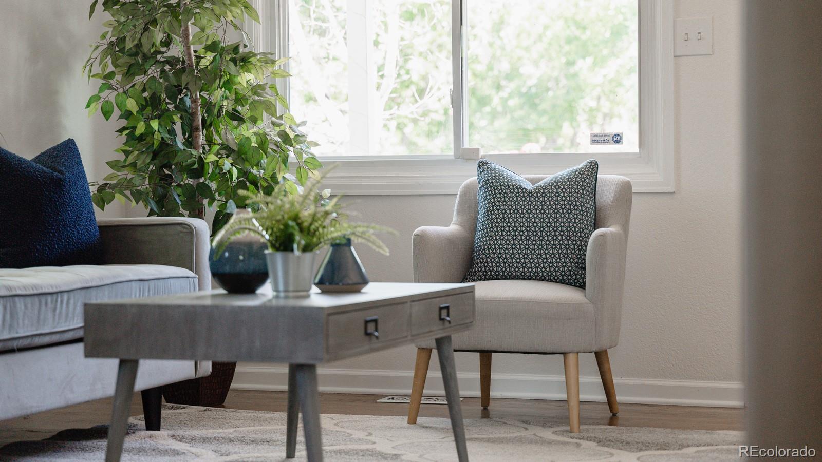 2260 Lilly Drive Thornton, CO 80229 - Photo 16 of 33 a view of a dining room with furniture window and wooden floor