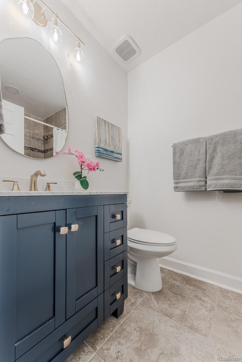 2260 Lilly Drive Thornton, CO 80229 - Photo 20 of 33 a bathroom with a sink vanity mirror and toilet