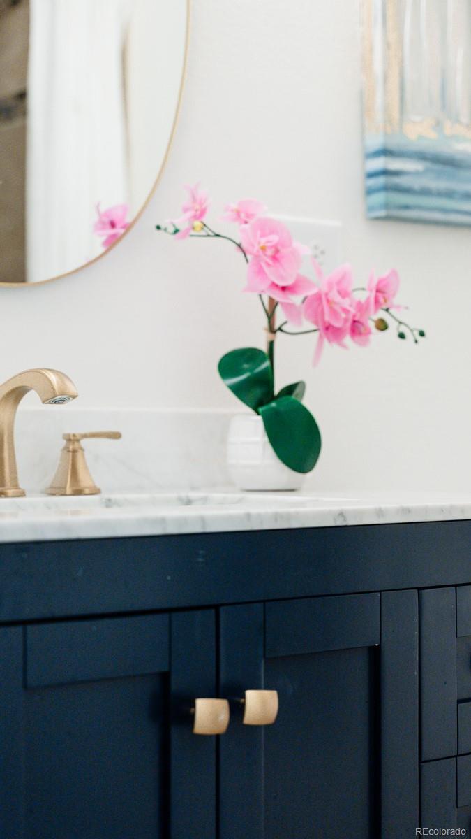 2260 Lilly Drive Thornton, CO 80229 - Photo 21 of 33 a bathroom with a sink and mirror