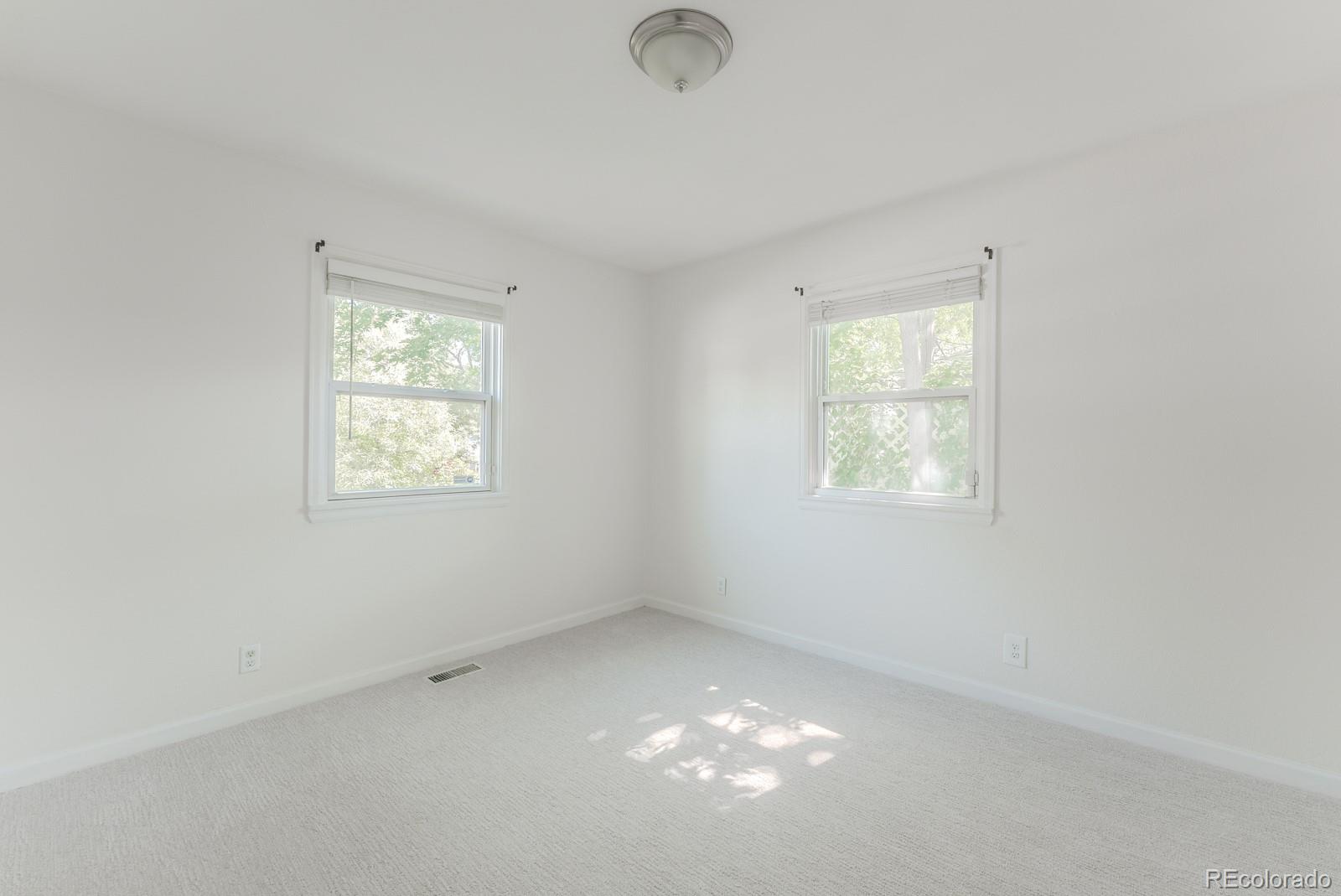 2260 Lilly Drive Thornton, CO 80229 - Photo 22 of 33 an empty room with windows