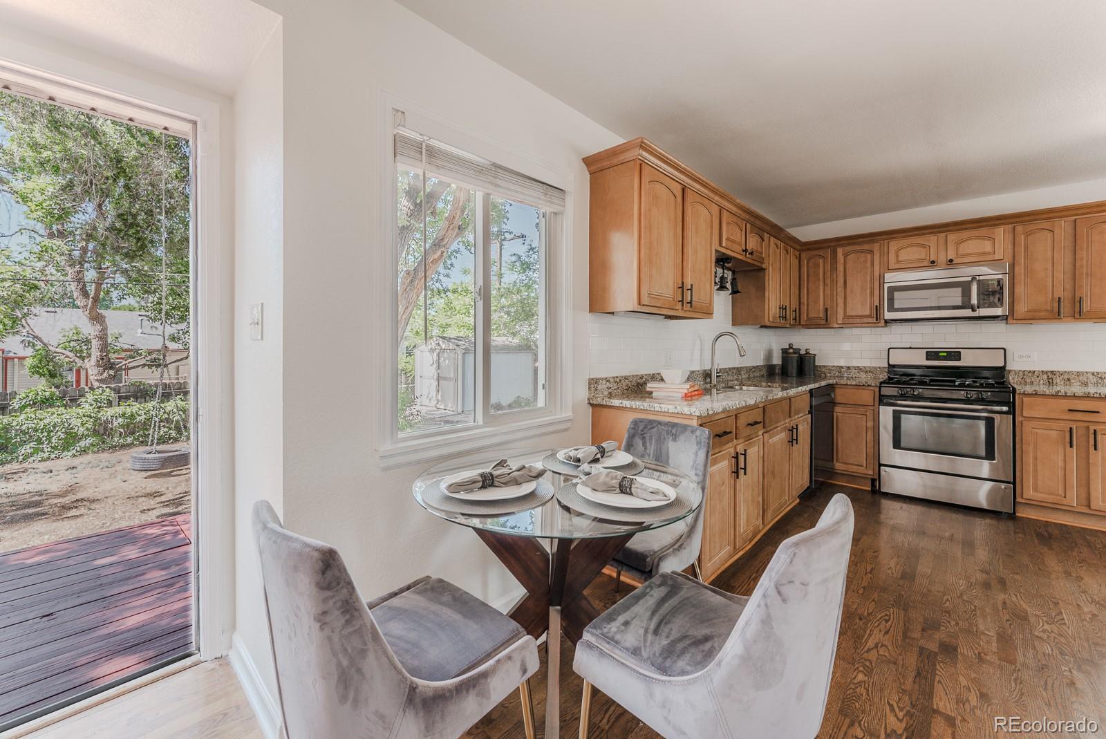 2260 Lilly Drive Thornton, CO 80229 - Photo 7 of 33 a view of a dining room with furniture window and wooden floor