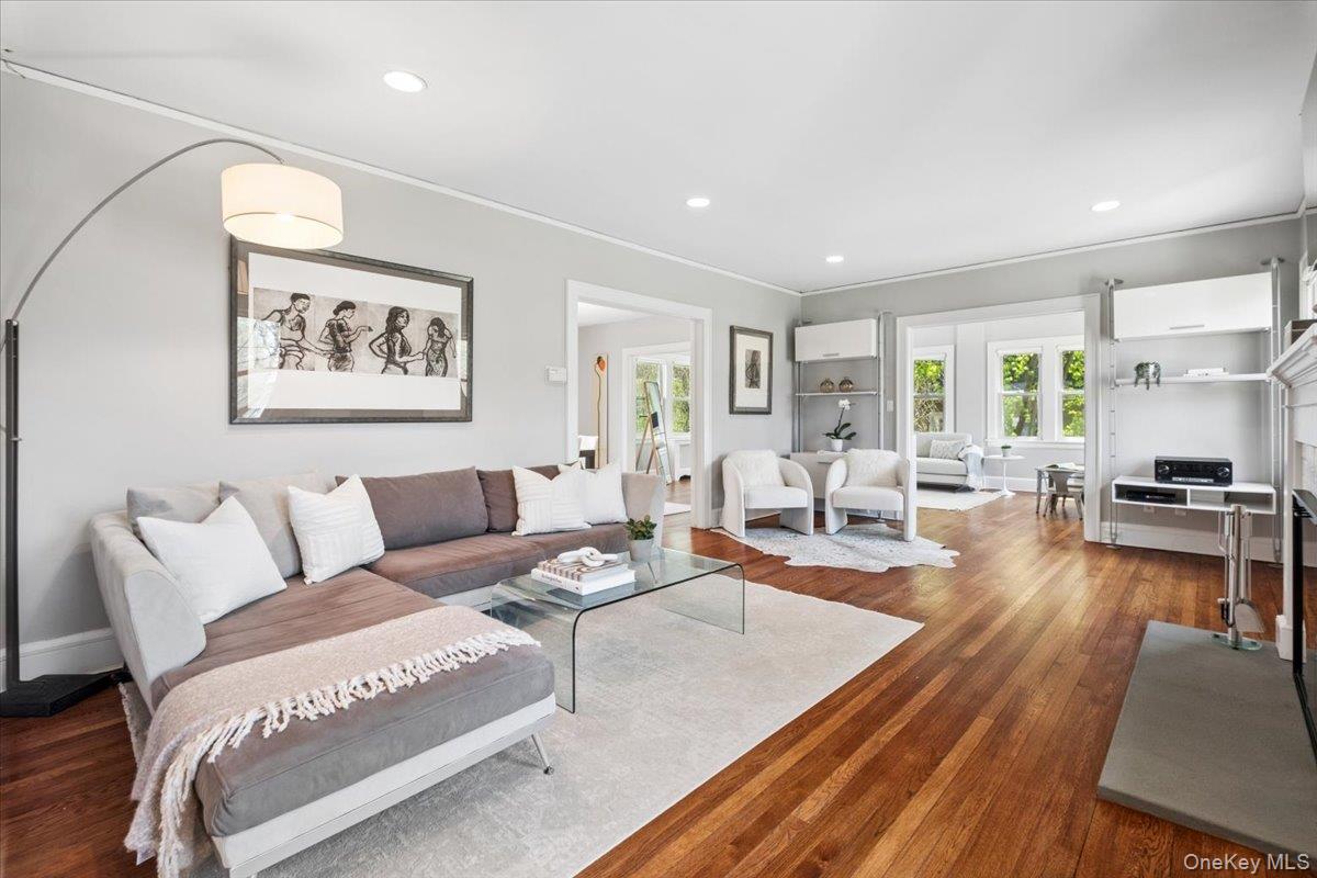 337 Heathcote Road Scarsdale, NY 10583 - Photo 4 of 33 Sunlit living room with wood-burning fireplace