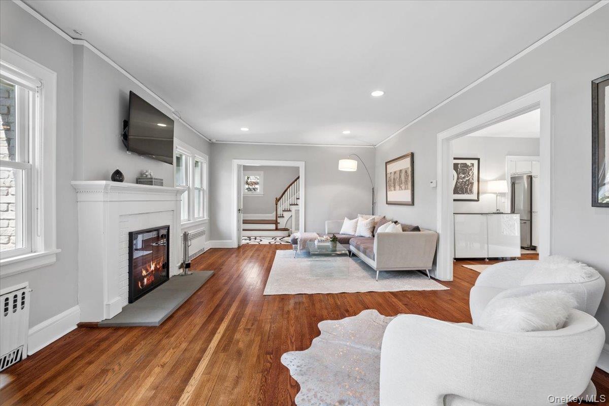 337 Heathcote Road Scarsdale, NY 10583 - Photo 5 of 33 Sunlit living room with wood-burning fireplace