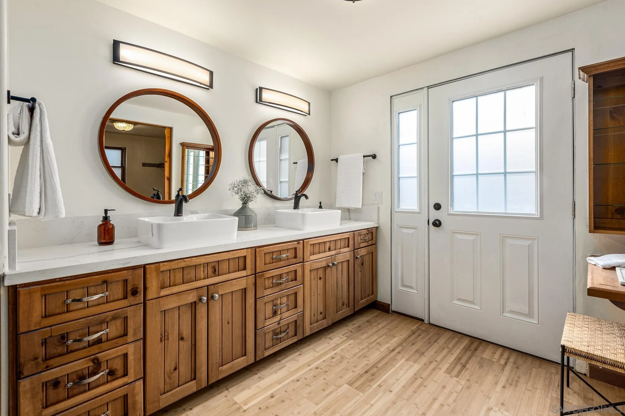 15315 Jenell Street Poway, CA 92064 - Photo 15 of 24 a bathroom with a double vanity sink and a mirror