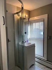 a bathroom with a shower and a sink