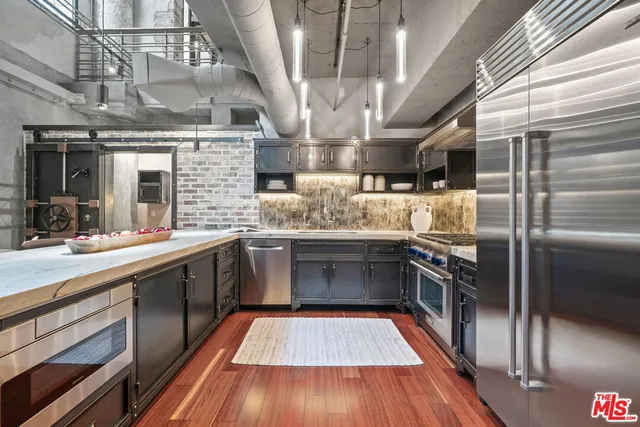 a kitchen with stainless steel appliances granite countertop a sink a counter space stainless steel appliances and cabinets