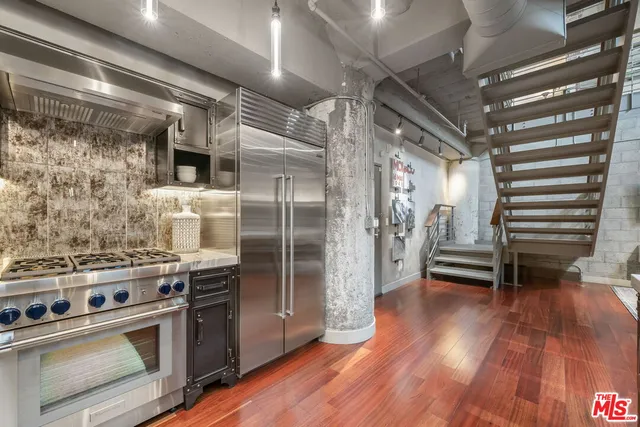 a kitchen with a stove and a refrigerator