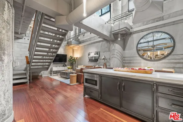 a kitchen with lots of counter top space and wooden floor