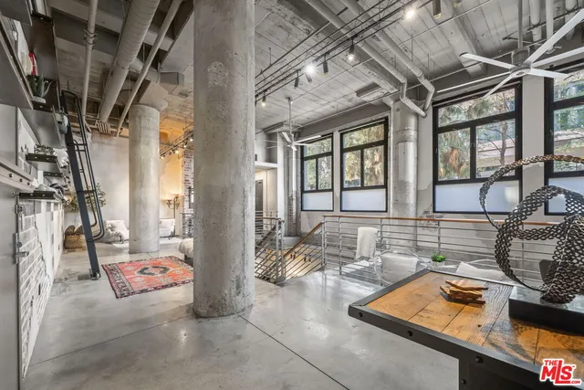 a kitchen with a sink and a stove next to a blue umbrella