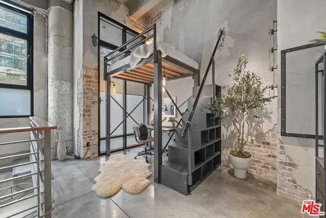 a livingroom with furniture and gym equipment