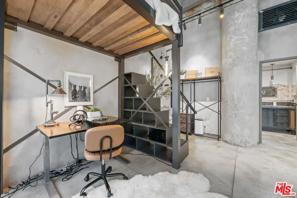 a large bed sitting in a room next to a window