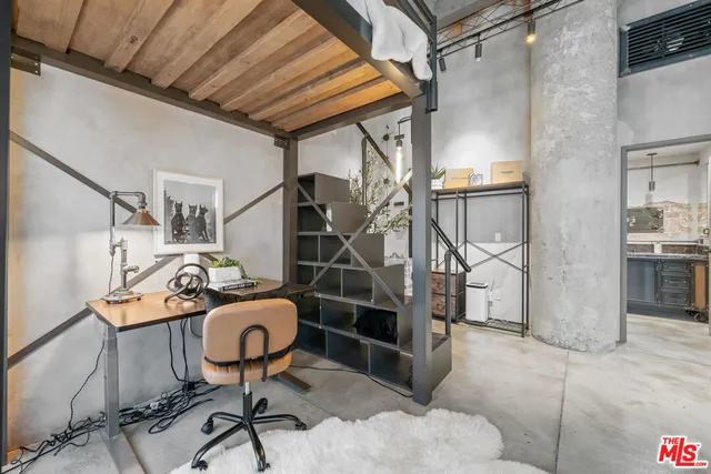 a large bed sitting in a room next to a window