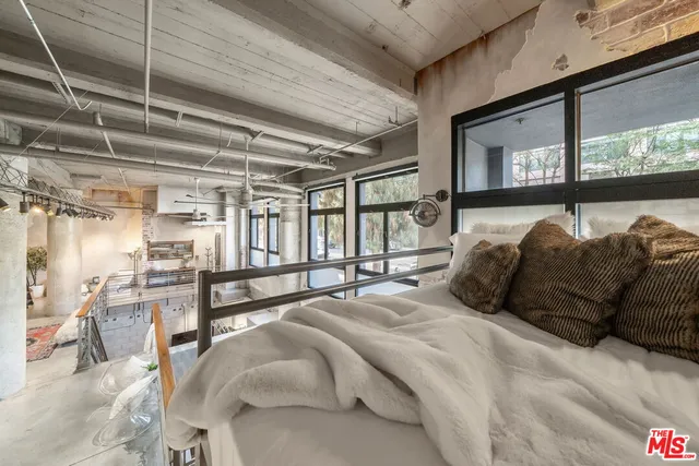 a bathroom with a granite countertop sink a toilet a mirror and shower