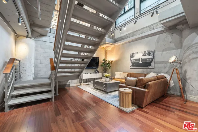 a living room with fireplace furniture and a wooden floor
