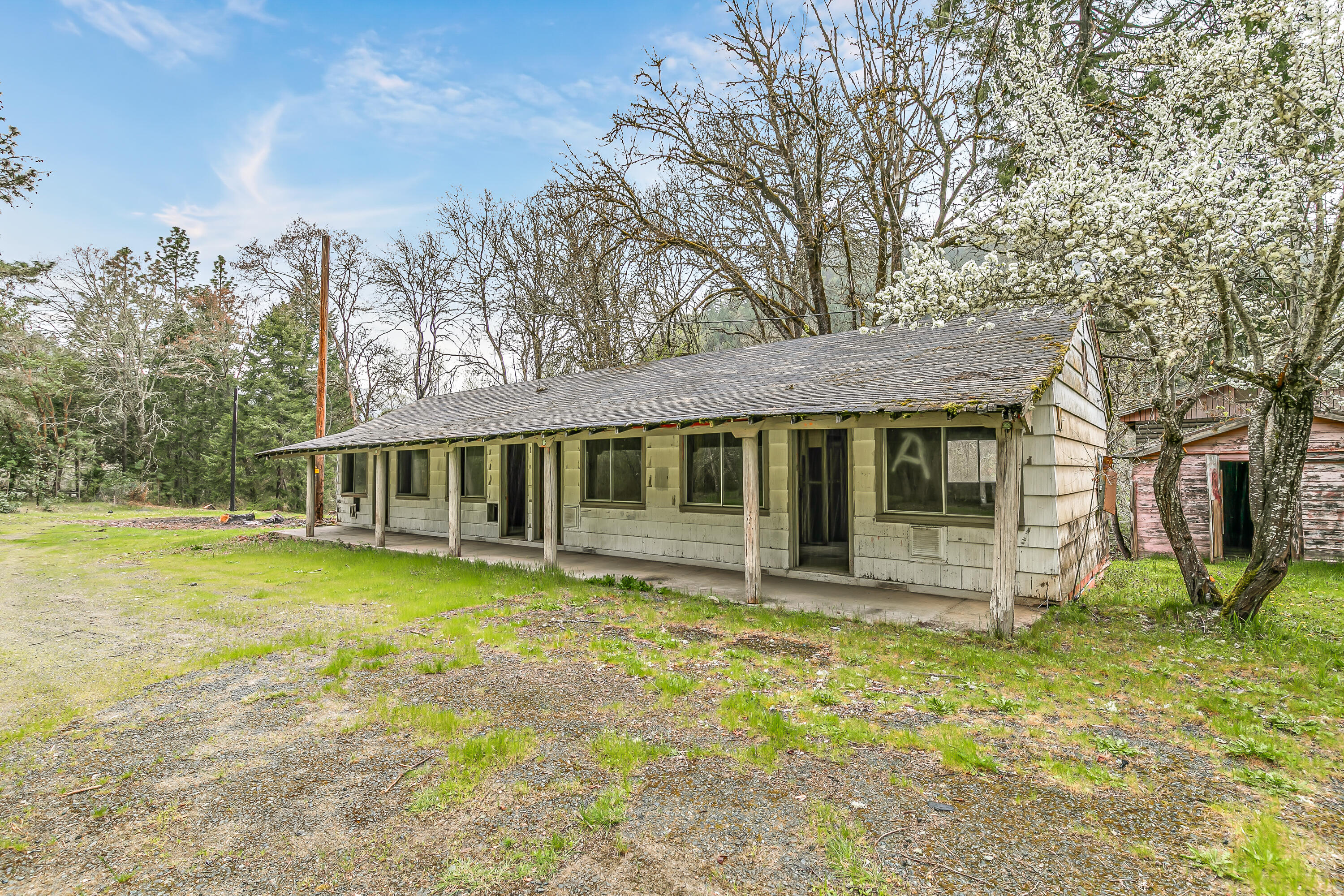 159 Bloom Road Wolf Creek, OR 97497 - Photo 15 of 38 a front view of a house with a yard