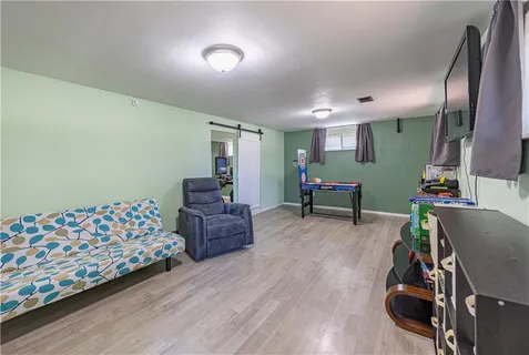 a bedroom with furniture and a wooden floor