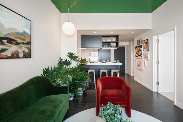 a living room with furniture and a potted plant