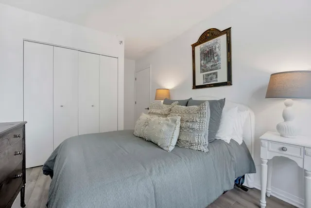 a bedroom with a bed and a lamp