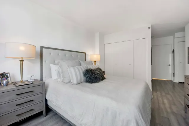 a bed room with a bed and a lamp