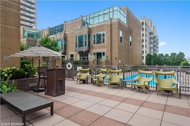 a view of a patio with table and chairs potted plants with wooden fence
