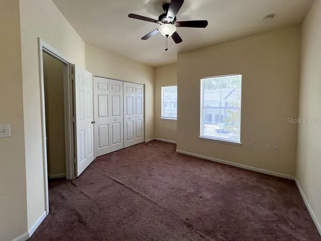a view of a livingroom with a ceiling fan and window