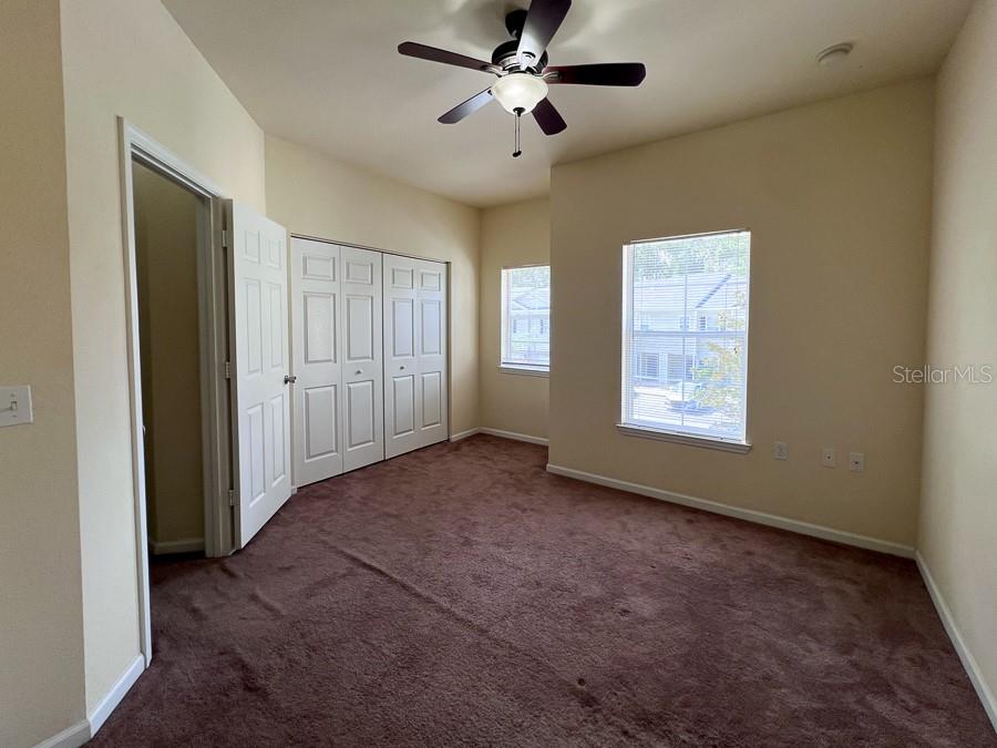 4886 Northwest 46th Place, Unit 106 Gainesville, FL 32606 - Photo 11 of 29 a view of a livingroom with a ceiling fan and window