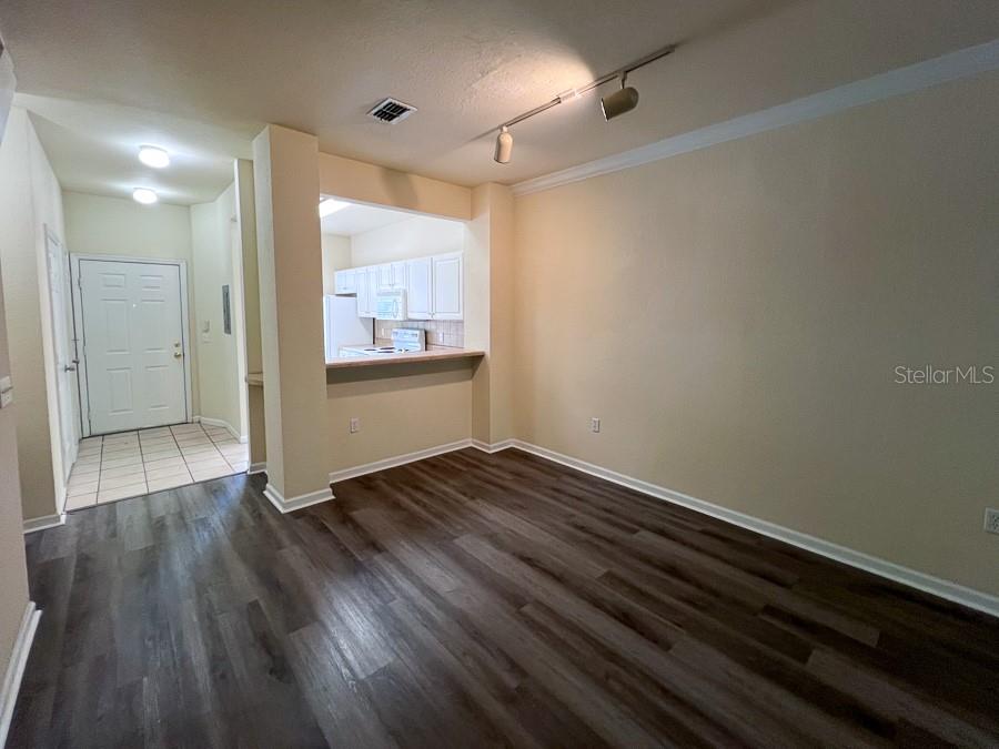 4886 Northwest 46th Place, Unit 106 Gainesville, FL 32606 - Photo 18 of 29 a view of an empty room with wooden floor and a window